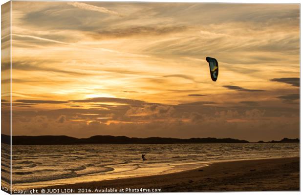 Kite surfer riding along the tideline at sunset Canvas Print by JUDI LION