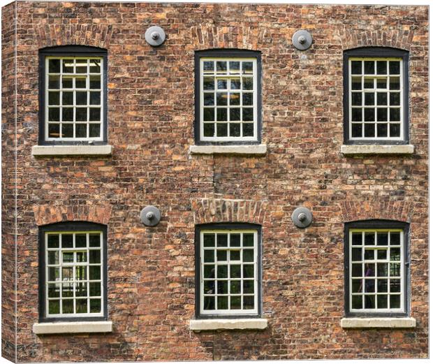 Restored industrial cotton mill with pattern of wi Canvas Print by Steve Heap