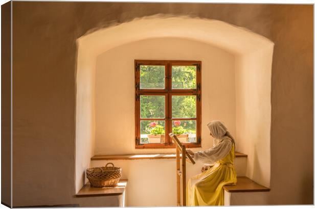 Woman working on embroidery in window alcove Canvas Print by Steve Heap