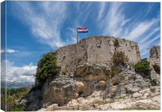 Flag on top of fortress above the Croatian town of Novigrad in I Canvas Print by Steve Heap