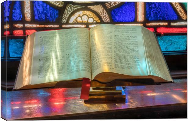 Light from stained glass window falls on open bible in american  Canvas Print by Steve Heap
