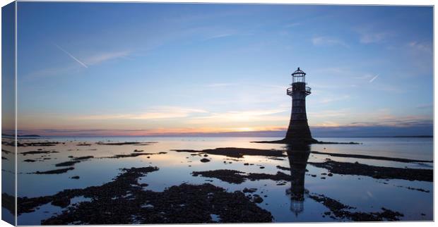 Lighthouse at sunset in silhouette, Canvas Print by Jackie Davies