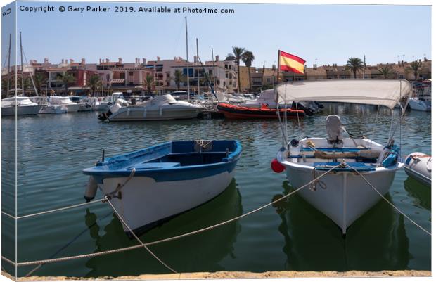 Small fishing boats moored in a Spanish harbour Canvas Print by Gary Parker