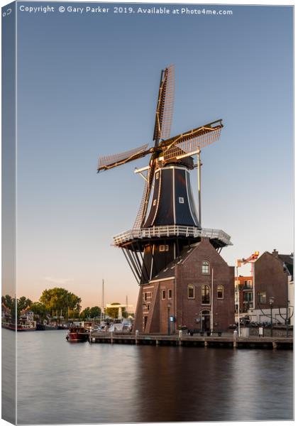 Dutch windmill, in the town of Haarlem, at sunset. Canvas Print by Gary Parker