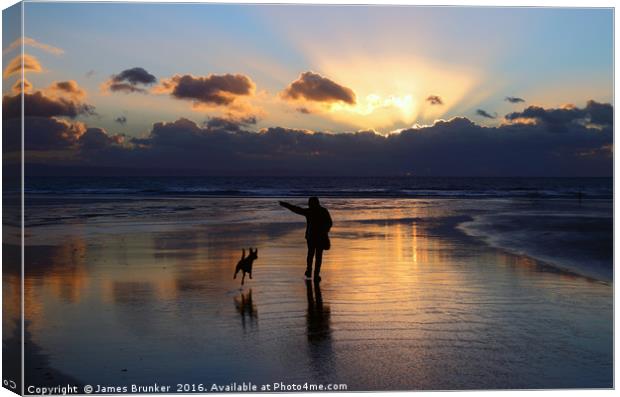 Walking the Dog at Sunset on Dunraven Bay Beach Canvas Print by James Brunker