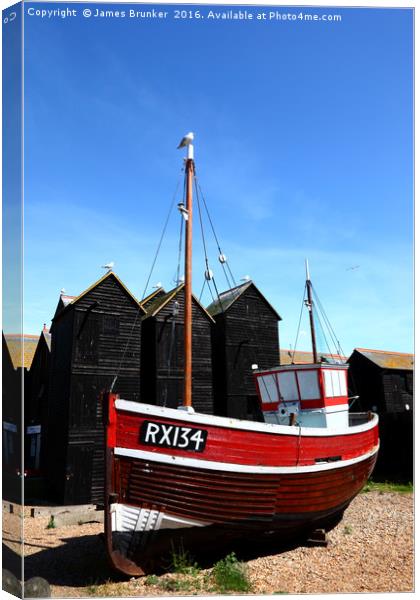 Fishing boat and historic net shops Hastings Canvas Print by James Brunker