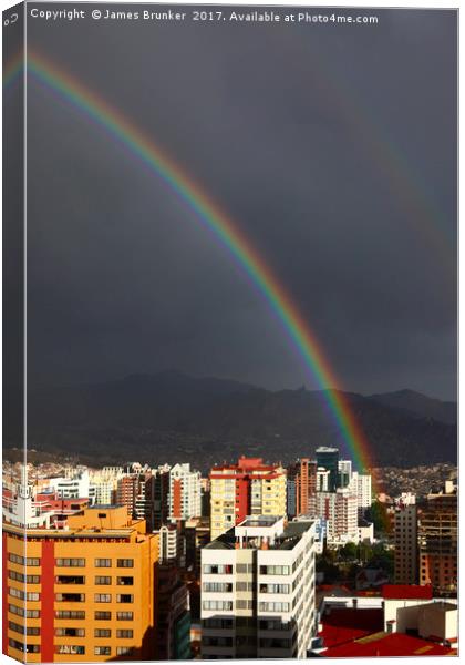 Rainbow Above La Paz CIty Centre Bolivia Canvas Print by James Brunker