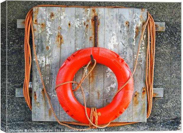 life buoy on a weathered wooden board with faded o Canvas Print by Philip Openshaw