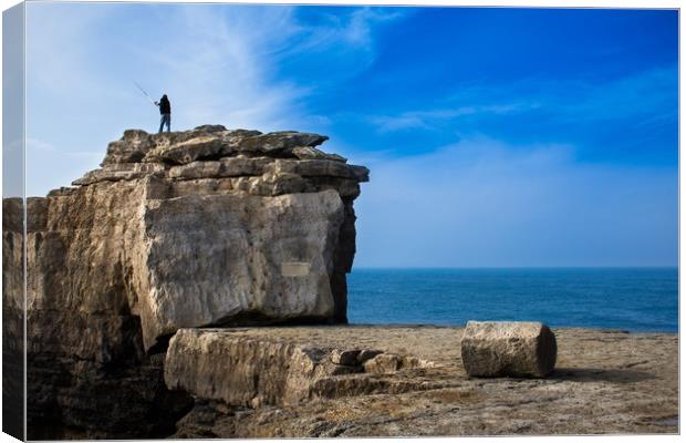 Fisherman casting a rod on the coast cliff rock Canvas Print by André Jorge