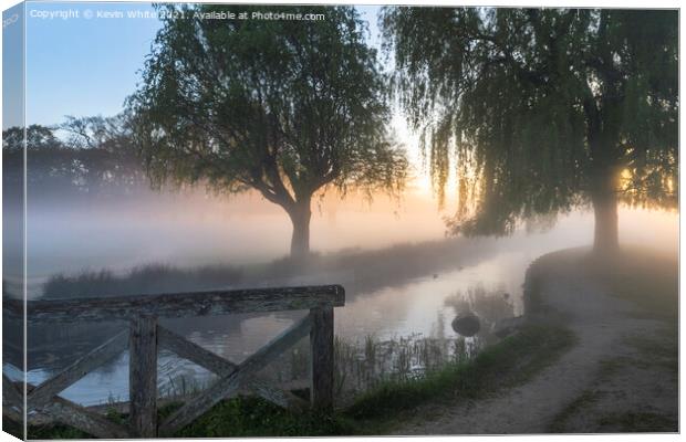 Sunrise by the stream Canvas Print by Kevin White