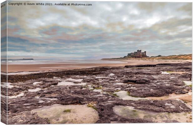 Bamburgh Castle under stormy sky Canvas Print by Kevin White