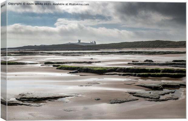 Dunstanburgh castle from Embleton beach Canvas Print by Kevin White