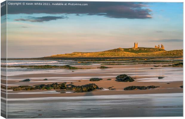 Sunsetting over Dunstanburgh castle on Embleton beach Canvas Print by Kevin White
