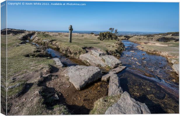Isolation by a Dartmoor stream with stone cross  Canvas Print by Kevin White