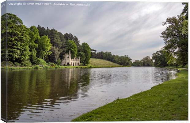 Vineyard and old ruin on the banks of Painshill Park lake Canvas Print by Kevin White
