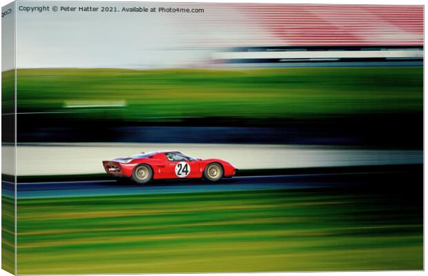 A fast red car on a track. Canvas Print by Peter Hatter