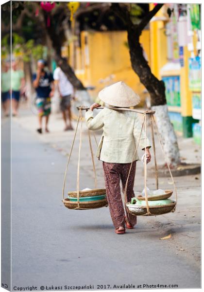 Vietnamese woman carrying products Canvas Print by Łukasz Szczepański