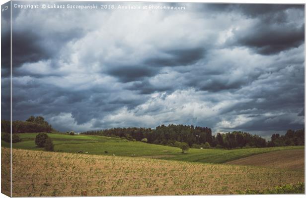 Stormy cloudscape over fields and pasture  Canvas Print by Łukasz Szczepański
