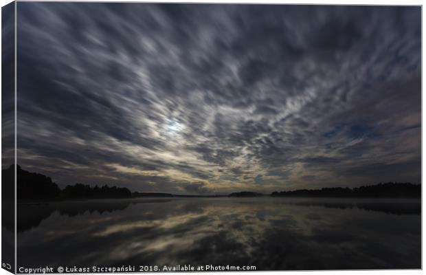 Dynamic clouds in the night over the lake lit by f Canvas Print by Łukasz Szczepański