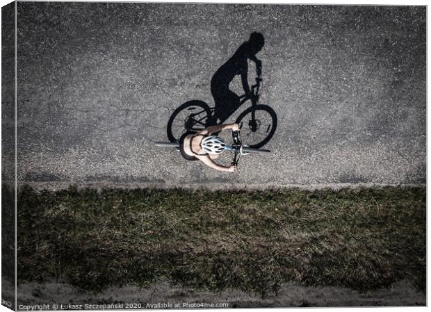 Cyclist on the road, top down image of shadow on t Canvas Print by Łukasz Szczepański