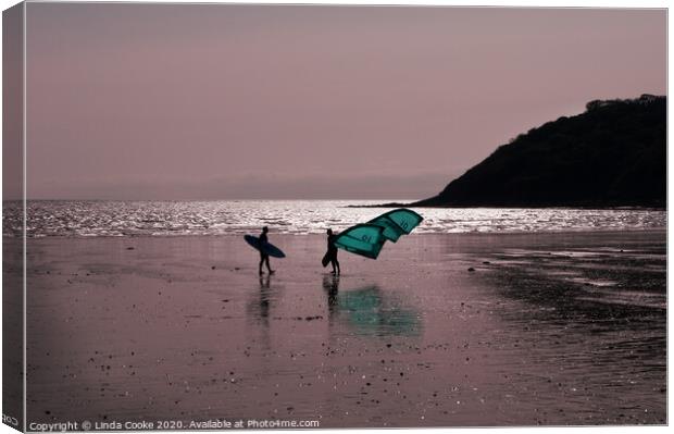 Surfer and windsurfer at Oxwich Canvas Print by Linda Cooke