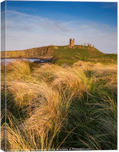 Golden light at Dunstanburgh Castle Canvas Print by Gary Clarricoates