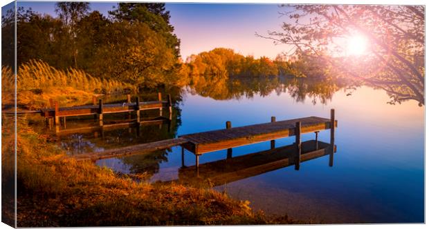 Wooden Jetties on a Becalmed Lake at Sunset Canvas Print by Alan Hill