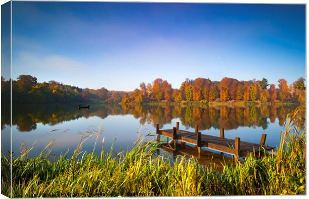 Still waters of a lake in autumn Canvas Print by Alan Hill