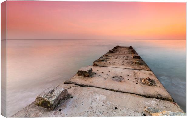 Stone jetty and calm seas Canvas Print by Alan Hill