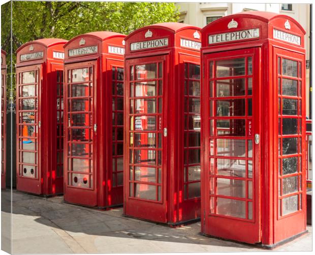 Four red telephone boxes in London Canvas Print by Alan Hill