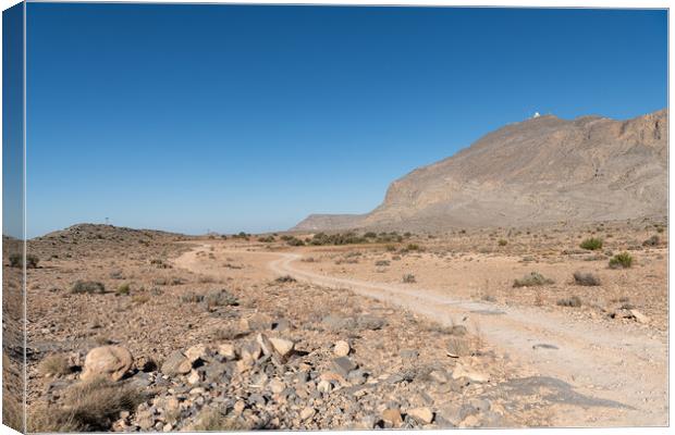 Track through the desert Harim mountains  in Musandam, Oman Canvas Print by Dave Collins