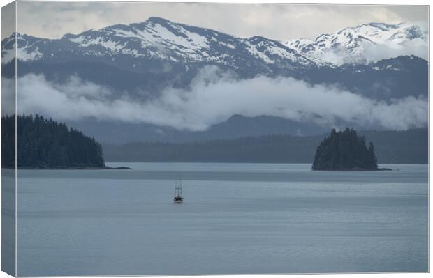 Commercial fishing boat  in Frederick Sound near Petersburg with clouds around the mountains beyond, Alaska, USA Canvas Print by Dave Collins