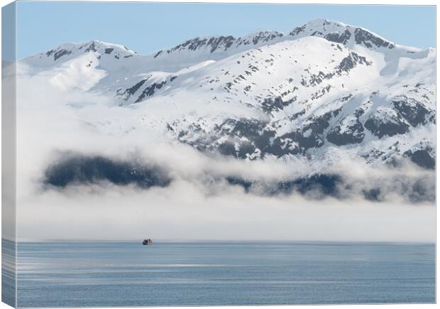 Boat approaching fog on the mountains and sea in Passage Canal, Whittier, Alaska USA Canvas Print by Dave Collins