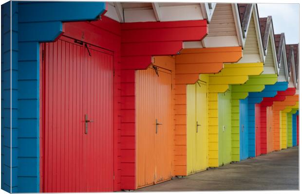 Colourful beach huts (de-focused near and far)  in a row on Scarborough North Bay Beach, Yorkshire, England Canvas Print by Dave Collins