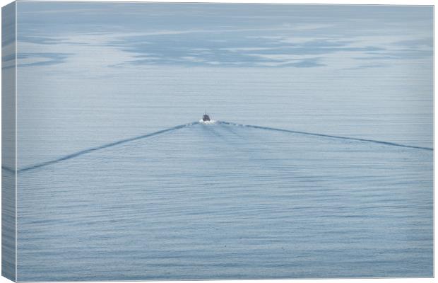 A small boat and its wake on a calm sea. Canvas Print by Dave Collins