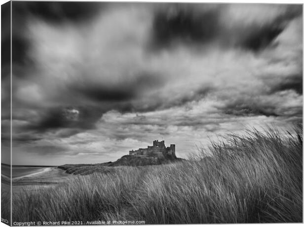 Gathering storm over Bamburgh Castle Canvas Print by Richard Pike
