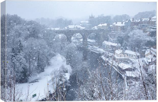 Winter snow over the river Nidd and famous landmark railway viaduct in Knaresborough, North Yorkshire. Canvas Print by mike morley