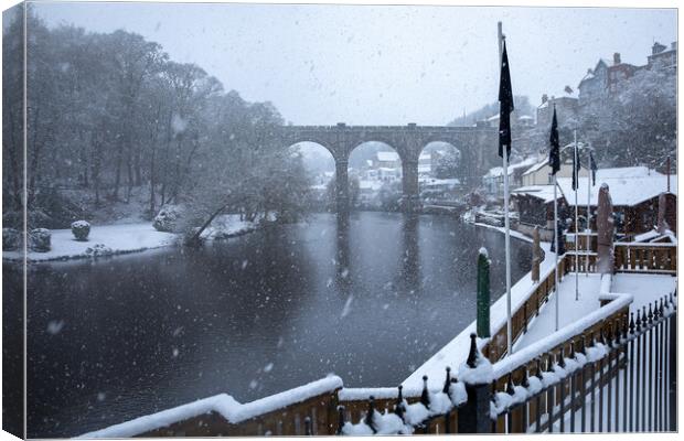 Winter snow over the river Nidd and famous landmark railway viaduct in Knaresborough, North Yorkshire. Canvas Print by mike morley