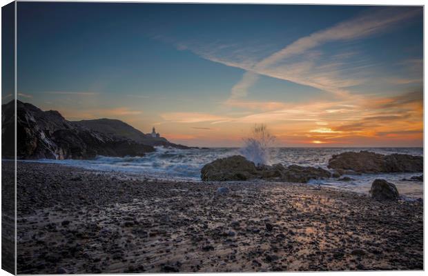 Wave splashing at sunrise at Mumbles. Canvas Print by Bryn Morgan