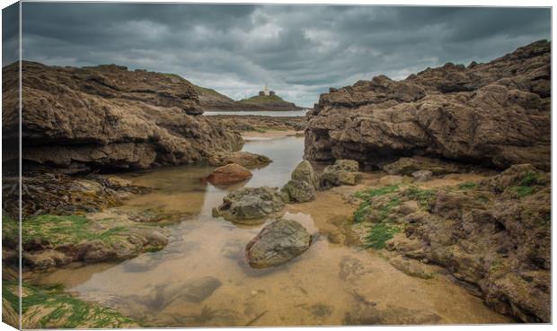 Mumbles lighthouse viewed from a rock pool. Canvas Print by Bryn Morgan
