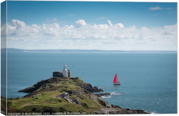 Yacht passing Mumbles lighthouse Canvas Print by Bryn Morgan