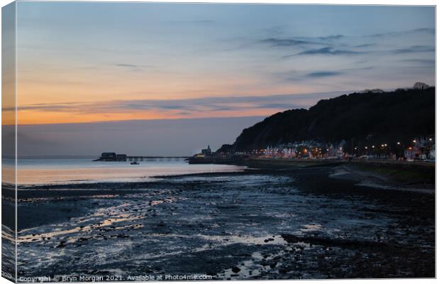 Mumbles pier and lighthouse at sunrise Canvas Print by Bryn Morgan