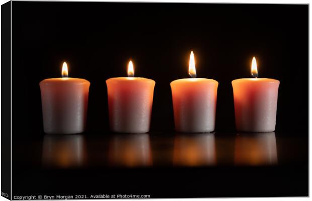Four burning candles Canvas Print by Bryn Morgan