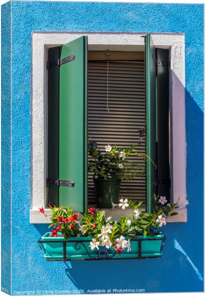 Window with Flowers in Burano Canvas Print by Chris Dorney