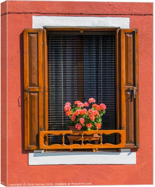 Window with Flowers in Burano Canvas Print by Chris Dorney