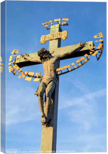 Crucifix Statue on the Charles Bridge in Prague Canvas Print by Chris Dorney