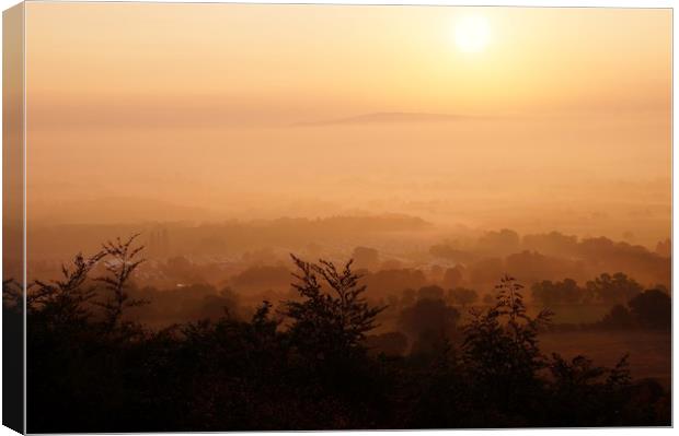                 Misty Sunrise over Bredon Hill     Canvas Print by John Iddles