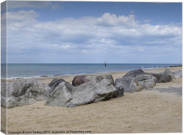 Rocks on the Beach - Cart Gap Beach Norfolk Canvas Print by john hartley