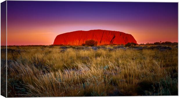 Fiery Skies over Uluru Canvas Print by John Frid