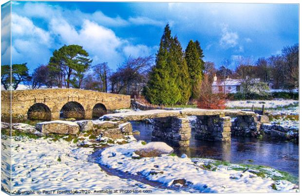 Snowy Medieval Clapper Bridge Canvas Print by Paul F Prestidge